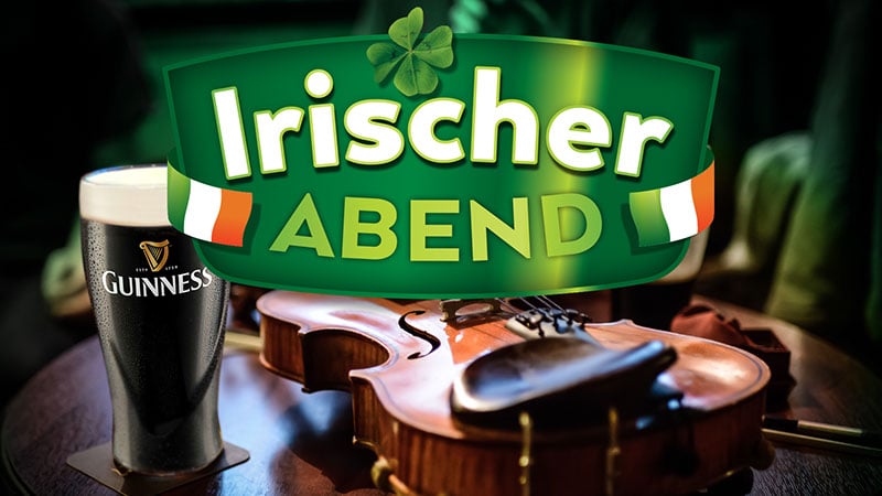 Ein Pint Guinness neben einer Geige auf einem Holztisch, darüber der Schriftzug "Irischer Abend" und irische Flaggen auf jeder Seite - perfekt für alle, die Sondershausen veranstalten oder einen authentischen Abend im Kyffhäuserkreis verbringen wollen.